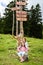 Children in frontÂ Wooden Signpost on Velika Planina in Slovenia